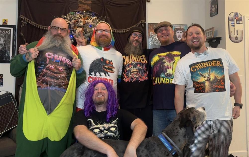 Chunder band members wearing assorted merch designs